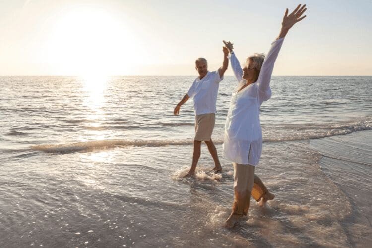 Couple walking on the beach after retiring to Benahavís - Retiring to Spain in 2026 and relocating to the Costa del Sol